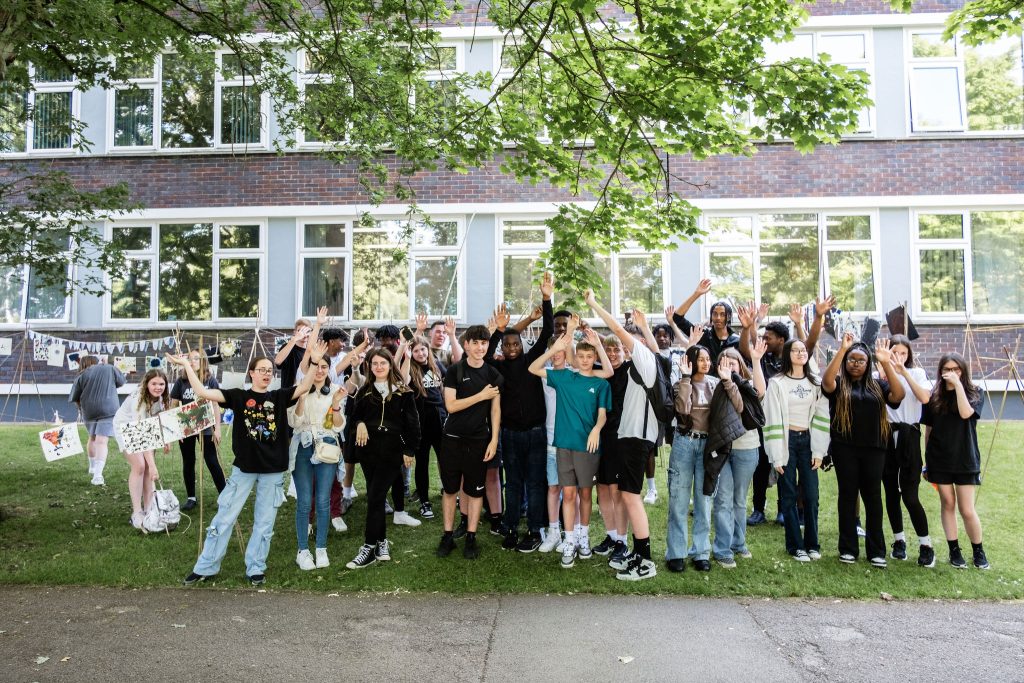 A group of young people celebrating the photo and the achievement.